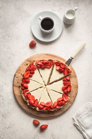 Cheesecake with fresh strawberries for dessert - healthy organic summer berry dessert cheesecake and coffee, copy space, top view. Homemade cheese cake.の写真素材