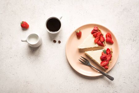 Cheesecake with fresh strawberries for dessert - healthy organic summer berry dessert cheesecake and coffee, copy space, top view. Homemade cheese cake.の写真素材