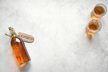 Kombucha fermented drink in glass and bottle on white background, copy space. Heathy probiotic drink - kombucha.の写真素材