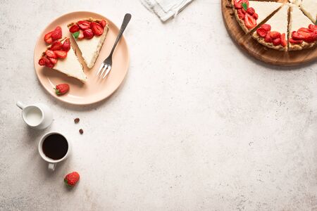 Cheesecake with fresh strawberries for dessert - healthy organic summer berry dessert cheesecake and coffee, copy space, top view. Homemade cheese cake.の写真素材
