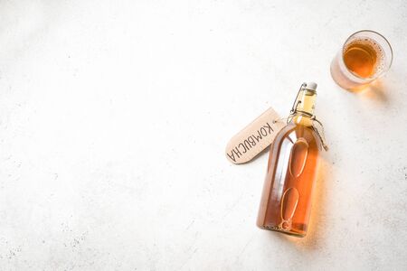 Kombucha fermented drink in glass and bottle on white background, copy space. Heathy probiotic drink - kombucha.の写真素材