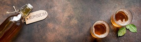 Kombucha or cider fermented drink on rustic background, copy space, banner. Heathy probiotic drink -...