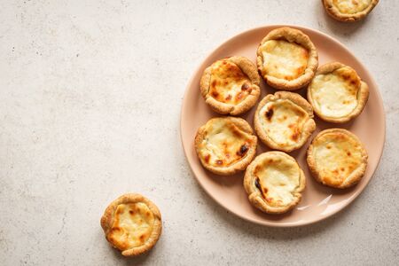 Portuguese custard tarts Pastel de Nata. Traditional Portuguese pasties for breakfast on white background, top view, copy space.の写真素材