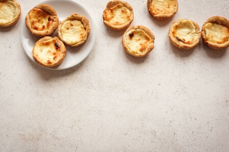 Portuguese custard tarts Pastel de Nata. Traditional Portuguese pasties for breakfast on white background, top view, copy space.の写真素材