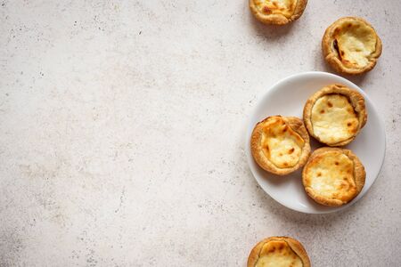 Portuguese custard tarts Pastel de Nata. Traditional Portuguese pasties for breakfast on white background, top view, copy space.の写真素材