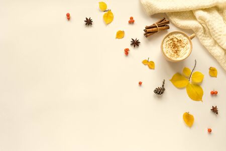 Autumn composition with coffee Pumpkin Spice Latte on white background. Cup of coffee with seasonal autumnal leaves, copy space.の写真素材