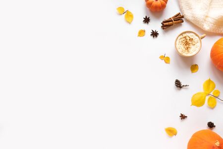 Autumn flat lay with coffee Pumpkin Spice Latte isolated on white background. Cup of coffee with seasonal autumnal leaves and pumpkins, copy space.の写真素材