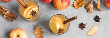 Spicy Apple Cider Drink. Seasonal autumnal homemade apple cider, top view, banner.
