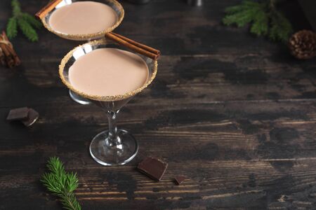 Chocolate Martini Cocktail in glasses for Christmas on dark wooden background, copy space. Homemade festive cocktail for winter holidays.の写真素材