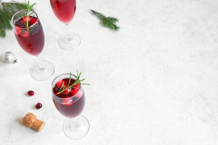 Christmas red cranberry mimosa with rosemary on white background, copy space. Cocktail with champagne for Christmas morning.の写真素材