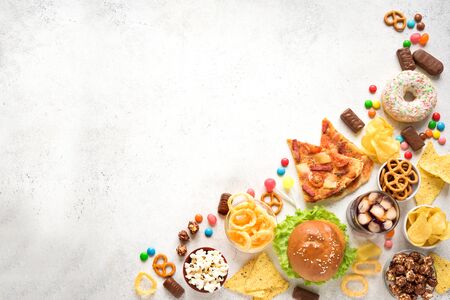 Assortment of Unhealthy Food on white, top view, copy space. Unhealthy eating, junk food concept.の写真素材