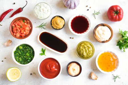 Set of various sauces. Popular sauces in bowls, top view, flat lay. Homemade sauces or dip.の写真素材