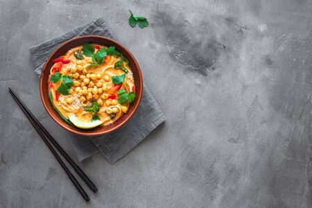 Vegetarian Laksa Soup. Vegetable noodle laksa soup on black background, top view, copy space. Asian Malaysian vegan vegetarian food.の写真素材