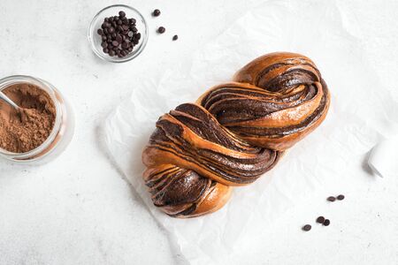 Chocolate Swirl Bread or Brioche Bread. Homemade sweet desert pastry - chocolate swirl bread (Babka) on white background, top view, copy space.の写真素材