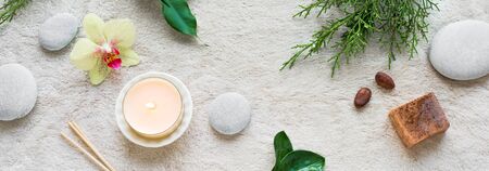 Spa concept on white soft towel background with natural cosmetic products, flower, green leaves,...