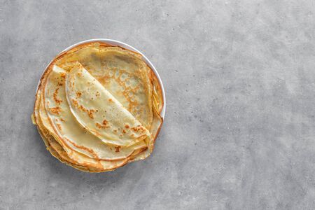 Crepes (Blini) on light grey background, top view, copy space. Homemade thin crepes for breakfast or dessert.の写真素材