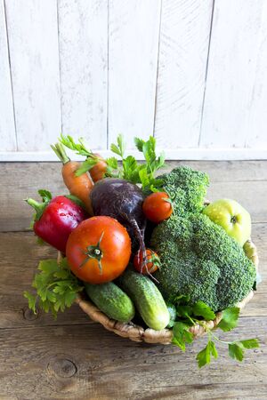 Organic Vegetables and Fruits on wooden table, copy space. Various raw healthy vegetables, diet and detox concept, clean eating ingredients.の写真素材