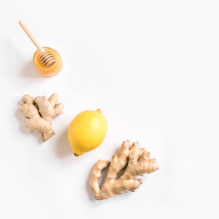 Fresh Ginger, Lemon and Honey isolated on white background, creative flat lay, copy space. Healthy...