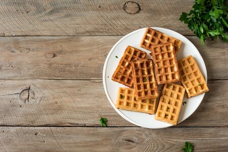Egg and cheese waffles (Chaffles)  for breakfast. Keto (ketogenic) recipe - morning savory protein waffles and ingredients, top view, copy space.の写真素材