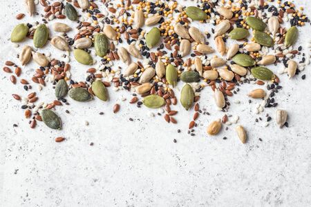 Pile of mixed seeds on white background, top view, copy space. Healthy Seeds Mix for Salads and healthy dishes.の写真素材