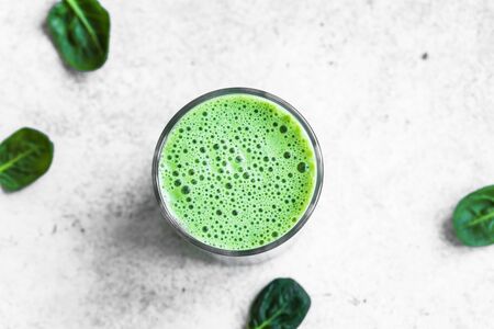 Green Smoothie Drink for healthy vegan detox breakfast, top view, copy space. Fresh spinach smoothie with bubbles close up.の写真素材