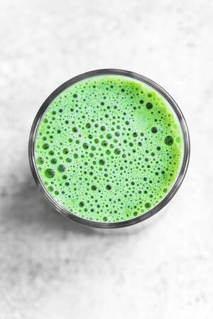 Green Smoothie Drink for healthy vegan detox breakfast, top view, copy space. Fresh spinach smoothie with bubbles close up.の写真素材