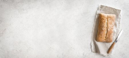 Ciabatta Bread. Fresh Homemade Italian Bread on linen napkin, white table, top view, copy space.の写真素材