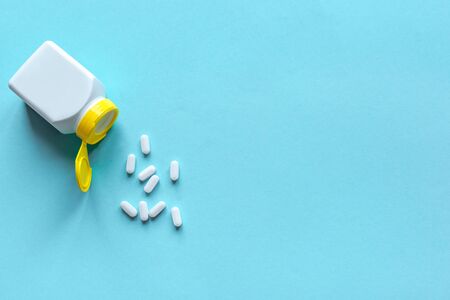 Pill Bottle and Pills on blue