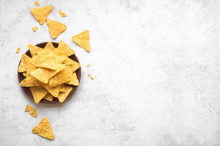 Mexican Corn Chips Nachos on white background, top view, copy space. Tortilla or Nacho Chips for...
