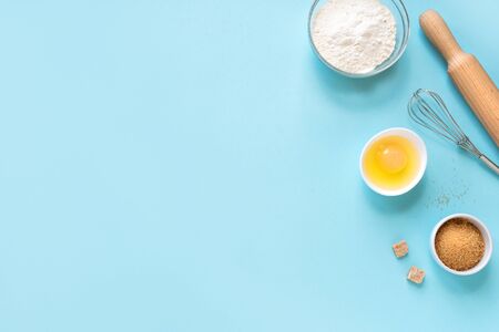 Baking utensils and ingredients on blue