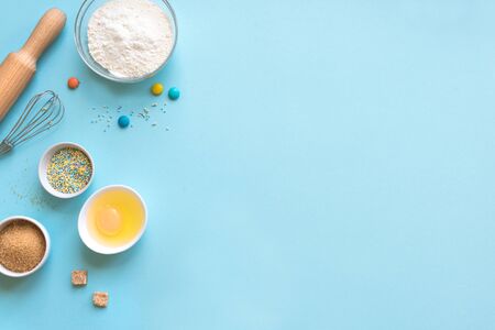 Baking utensils and ingredients on blueの写真素材