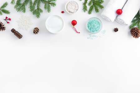 Christmas Spa Concept and Winter Skin Care products, fir branches and snowflakes on white background, flat lay, copy space. Seasonal beauty routine and skin care concept.の写真素材