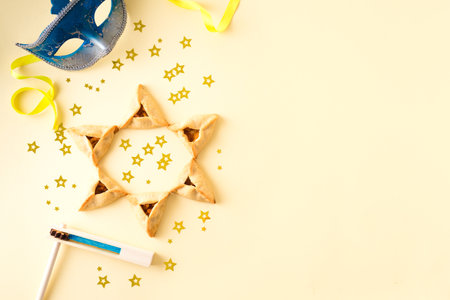 Purim celebration concept (jewish carnival holiday) on yellow background, top view, copy space. Purim flat lay.の写真素材