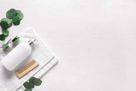 Organic Hair Care product, eco wooden comb with green leaves on white background, copy space. Trendy flat lay of eco beauty and healthy lifestyle concept.の写真素材