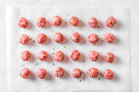 Raw meatballs on white background, top view. Beef meatballs ready for cook.