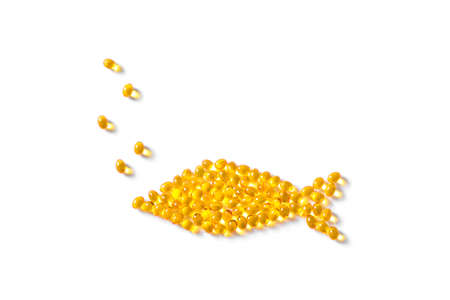 Omega 3 fish oil capsules (softgels) in shape of fish. Yellow softgels isolated on white, top view, copy space.