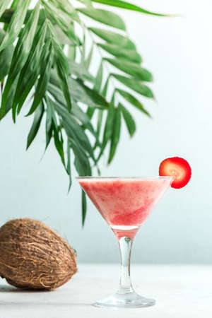 Coconut Strawberry Daiquiri or Margarita Cocktail. Frozen summer delicious rum cocktail or slushie drink on light background, copy space.の写真素材