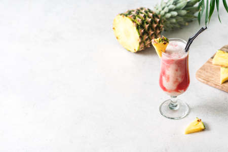 Lava Flow Cocktail - delicious summer tropical drink with rum, strawberry, coconut cream and pineapple juice. Glass of hawaiian cocktail on light background, copy space.の写真素材