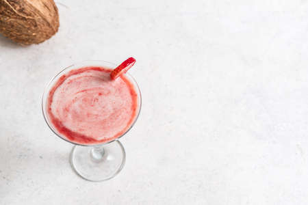 Coconut Strawberry Daiquiri or Margarita Cocktail. Frozen summer delicious rum cocktail or slushie drink on light background, copy space.の写真素材