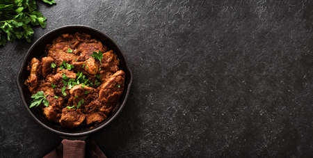 Meat Stew. Beef goulash in vegetable sauce, top view, copy space. Slow cooked braised meat in cast...