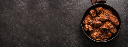 Meat Stew. Beef stewed in red wine sauce, top view, copy space. Slow cooked braised meat in cast iron pan.の写真素材