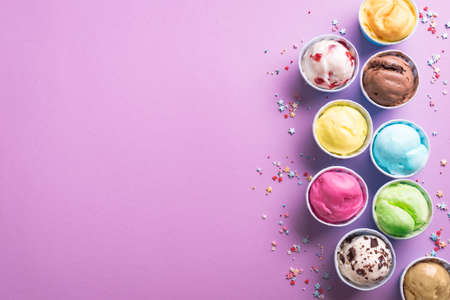 Ice Cream Assortment. Various ice creams or gelato on purple background, copy space. Frozen yogurt...