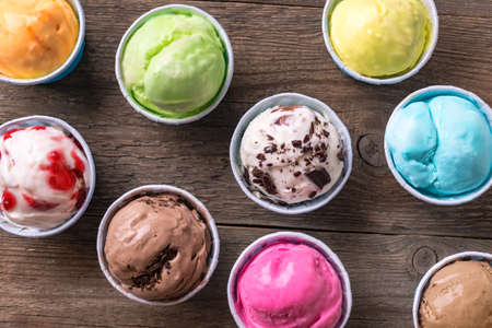 Ice Cream Assortment. Various ice creams or italian gelato on wooden background, close up. Frozen...