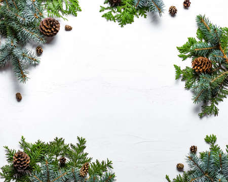 Christmas background with pine branches and cones on white, top view, copy space. Merry christmas...