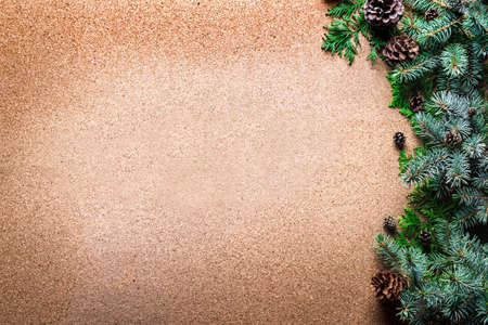 Christmas background with pine branches and cones on wooden, top view, copy space. Merry christmas...