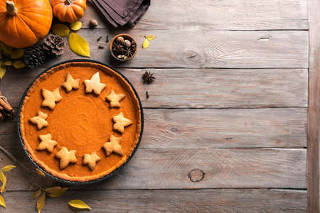 Pumpkin Pie on wooden background, top view, copy space. Homemade pastry for Thanksgiving holiday - traditional autumn Pumpkin Pie or tart.の写真素材