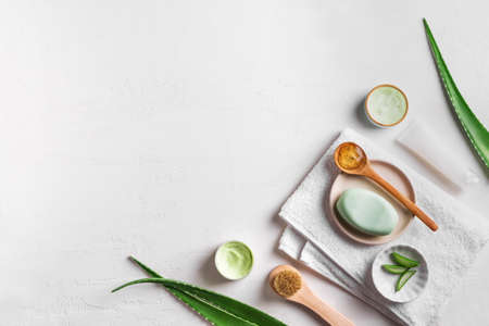 Aloe vera plant leaves, gel, skin care products on white, top view, copy space. Natural organic aloe vera cosmetics for face, hair and body care.の写真素材