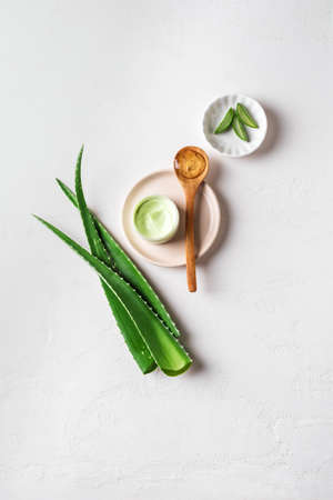 Aloe vera plant leaves, gel, skin care products on white, top view, copy space. Natural organic aloe vera cosmetics for face and body care.の写真素材