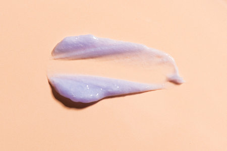 Purple blonde hair shampoo on beige background. Swatch of cooling shampoo or conditioner for blonde hair.の写真素材