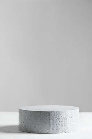 Empty stone podium on gray backdrop, scene with copy space for your products presentation. Empty modern minimal concept mock up for cosmetic, skin care and other products advertising.の写真素材